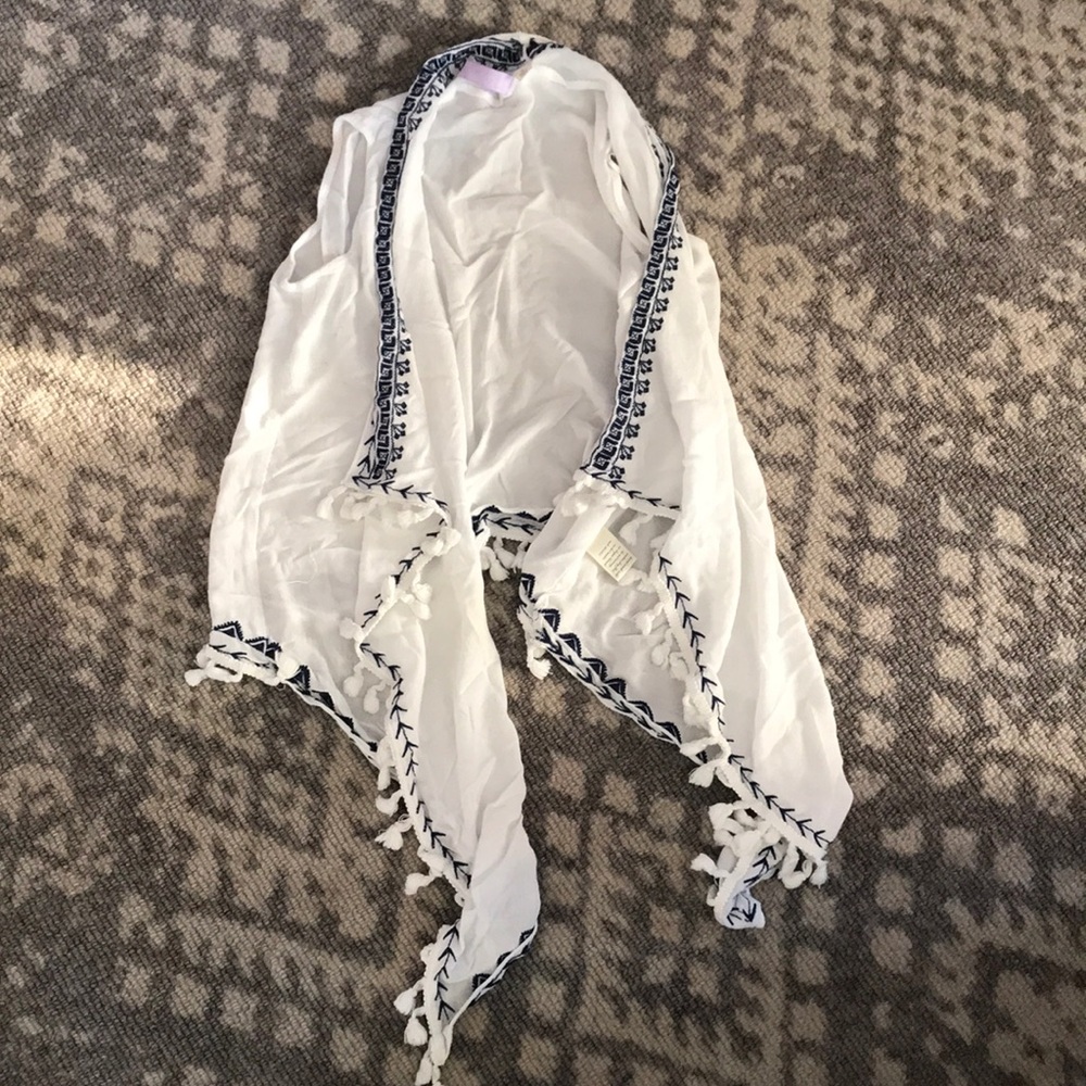 White & blue tasseled shawl.